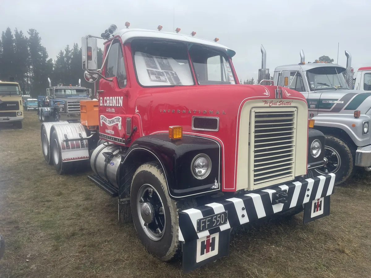 A red and maroon International bonneted truck signwritten B Cronin, Gore, with a chrome grille