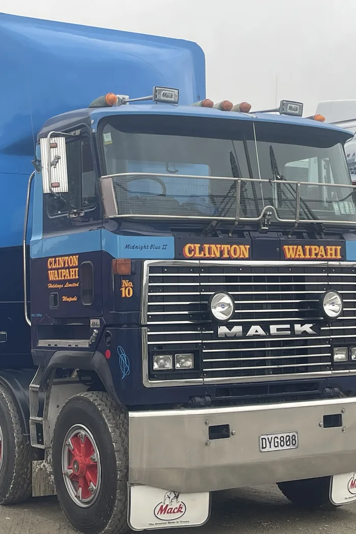 A blue Mack stock truck signwritten Clinton Waipahi, parked on gravel
