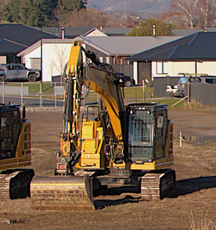 A new Caterpillar 325 excavator on a residential site