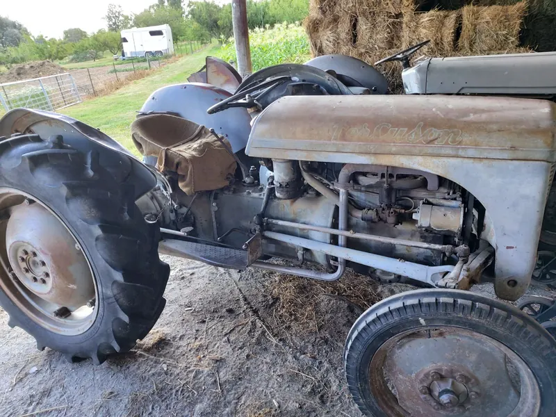 A grey Ferguson TEA tractor, close up on its rear wheel and engine