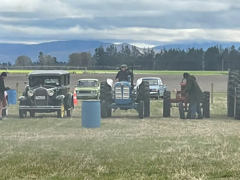 A blue Fordson Super Major lined up with vintage cars at a rally