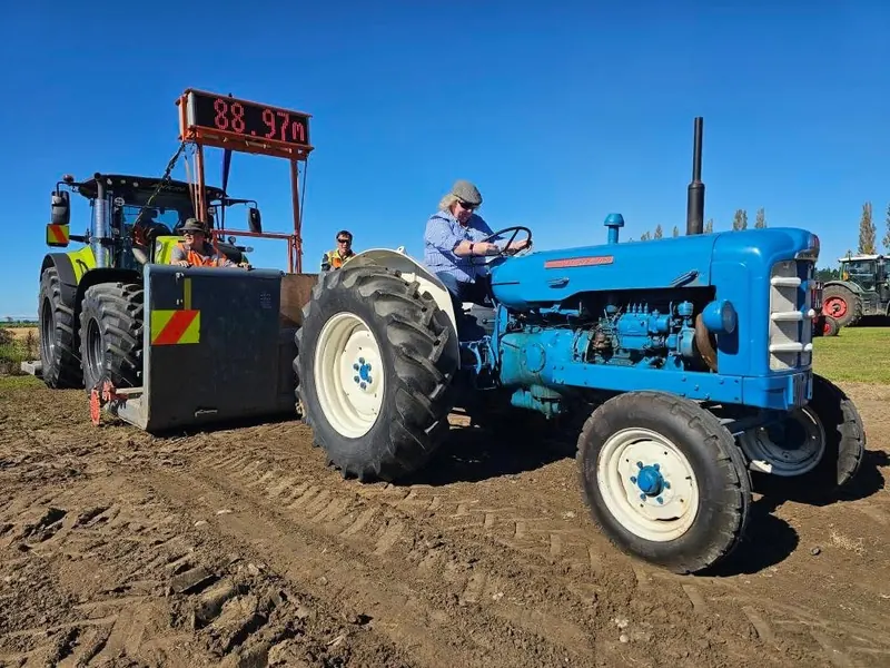 A blue Fordson Super Major pulling the sled