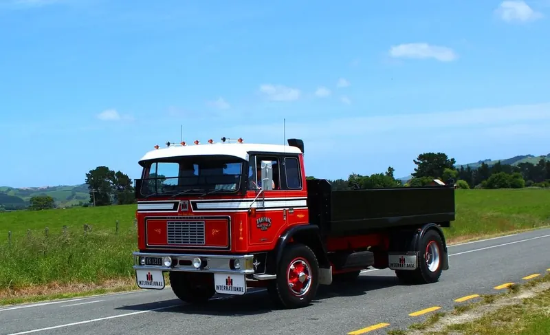 A red International 1830A tipper on a country road
