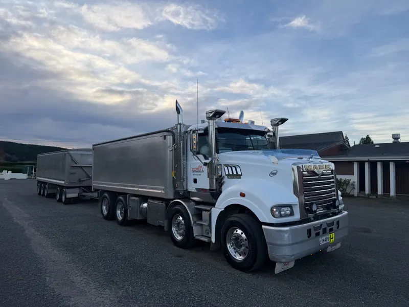 A white Mack Superliner with a tipper trailer