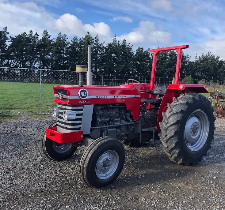 A red Massey Ferguson 165 on a gravel yard