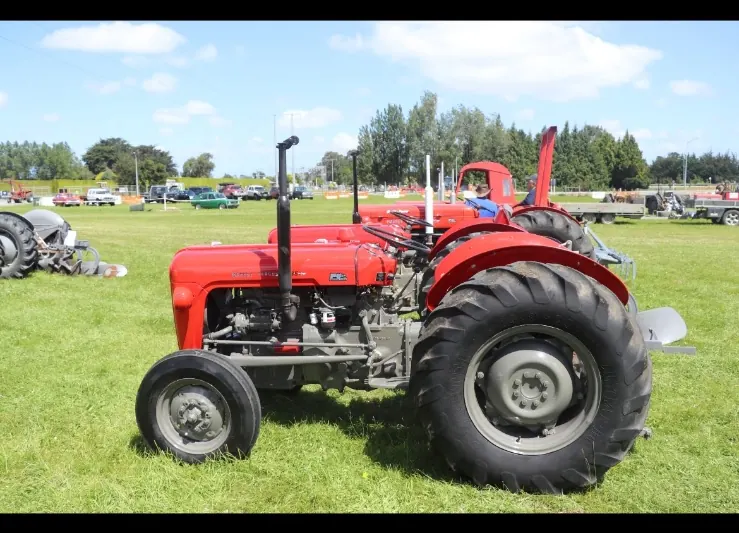 A red Massey Ferguson 35X on grass at a tractor show