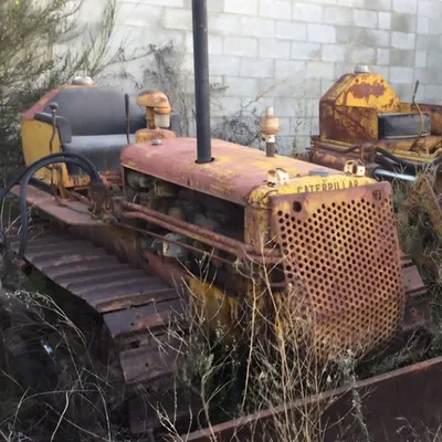 An unrestored vintage crawler tractor